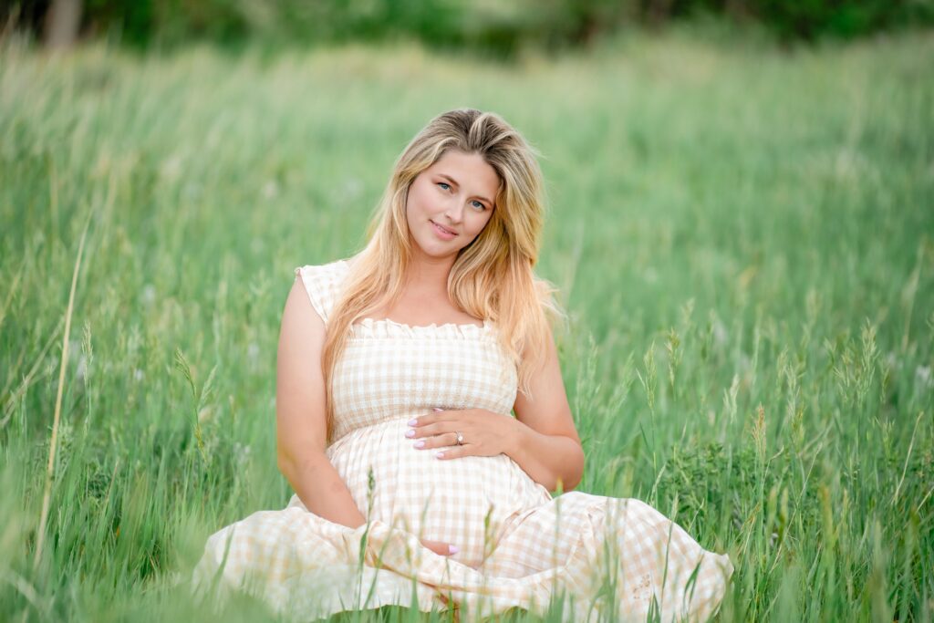 Pregnant woman maternity session in light neutral dress dreamy park session in southern colorado