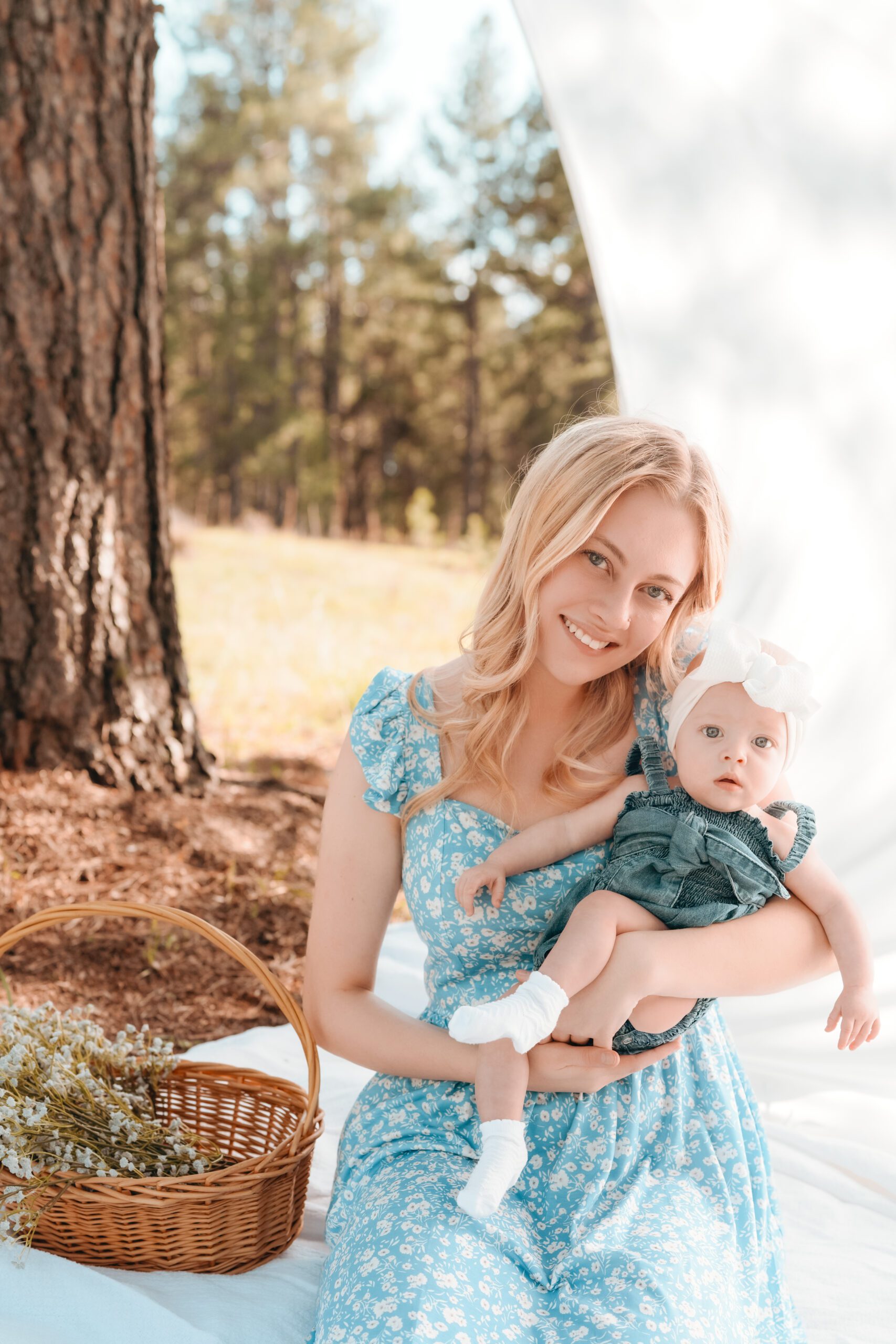 Motherhood minis mini session in Colorado Springs, Colorado. Mother in blue dress holding baby