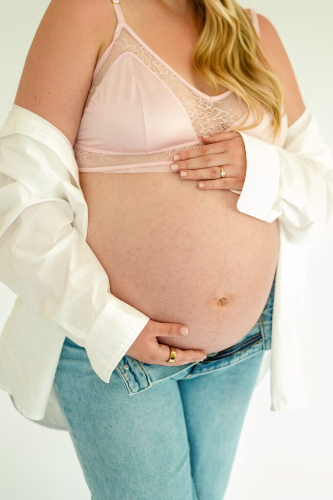 Studio maternity session with pregnant mama holding flowers and it's springtime